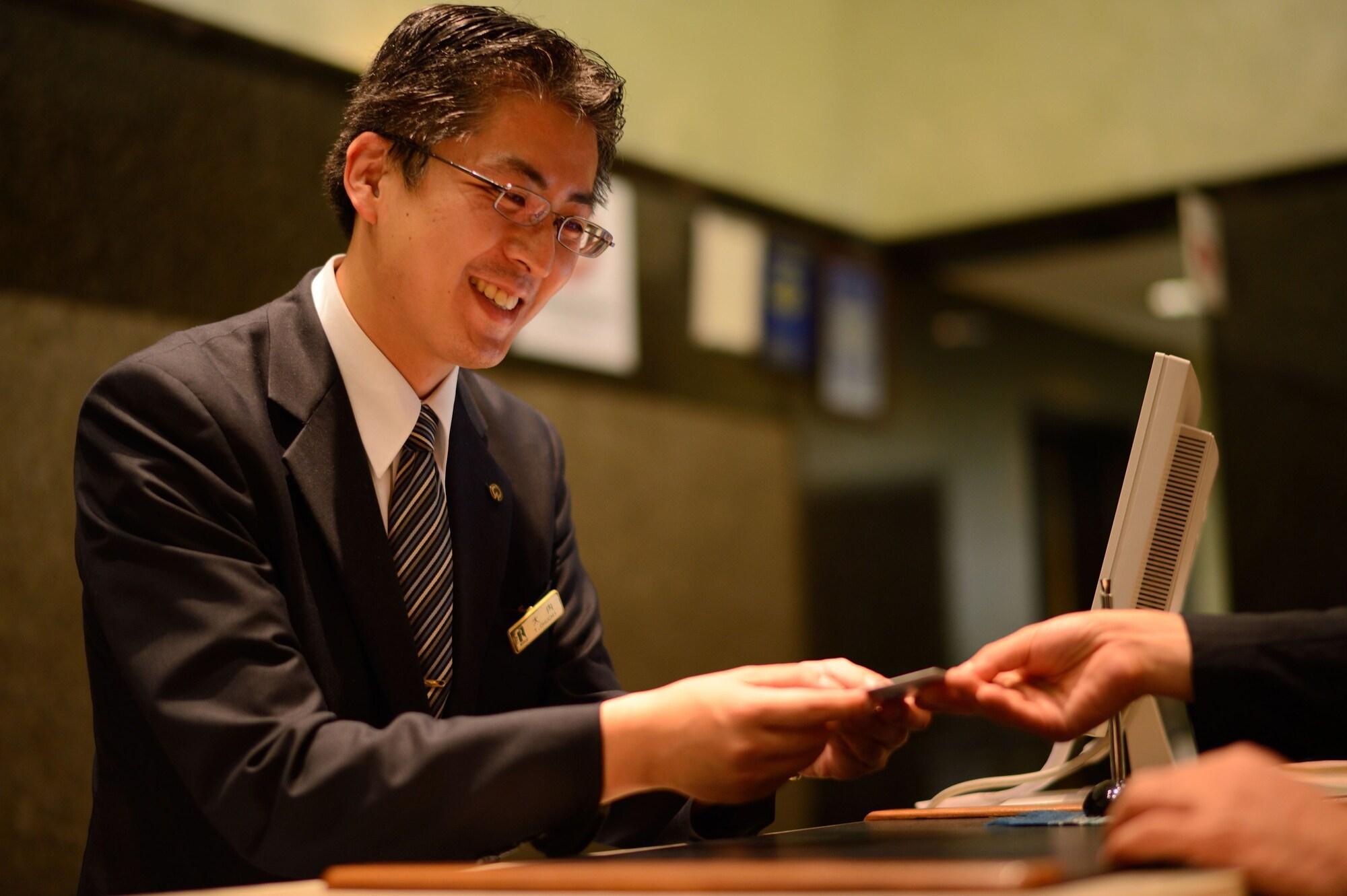 Royton Sapporo Hotel Екстер'єр фото A hotel clerk at the front desk